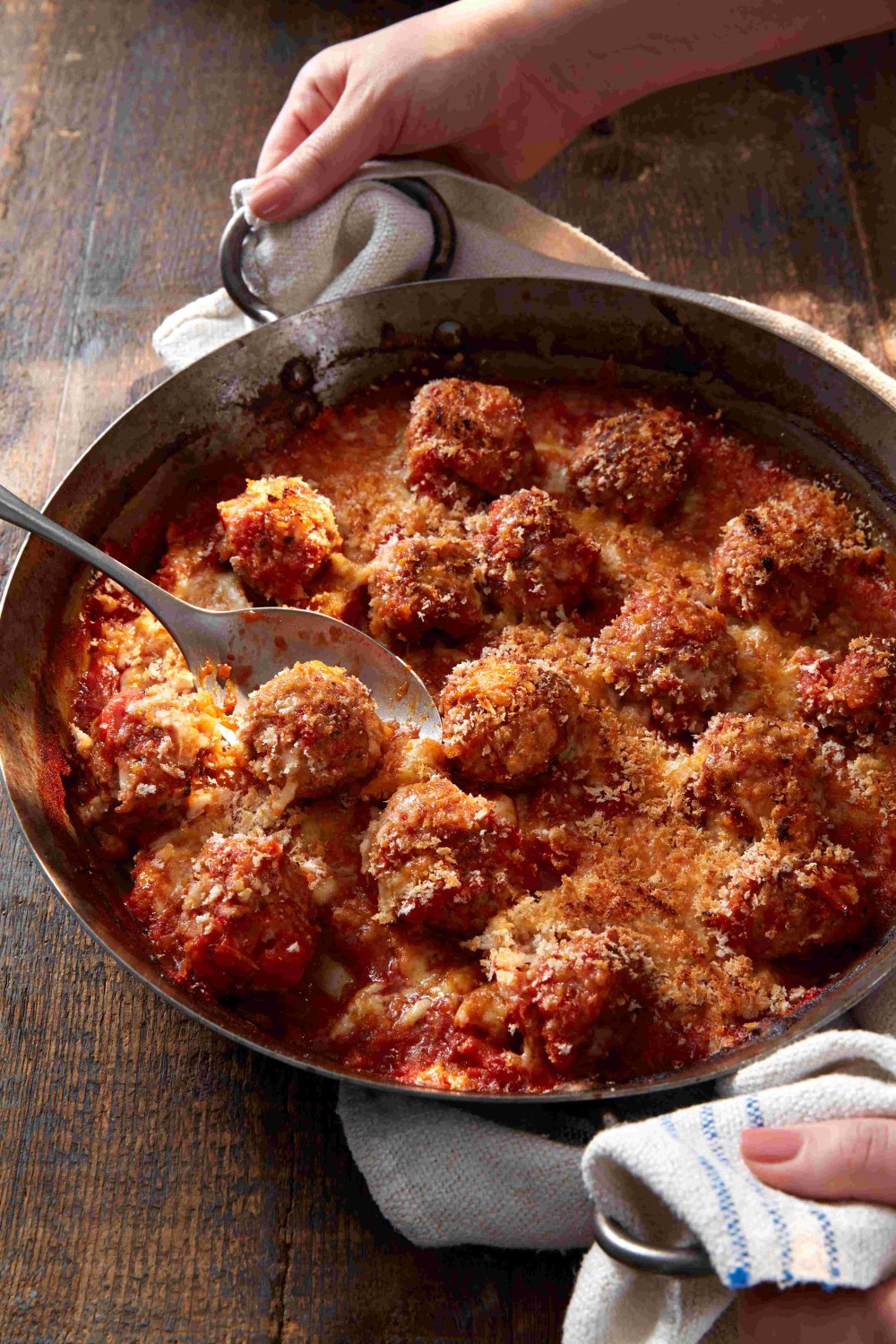 A LovePork recipe of meatballs in tomato sauce with a cheesy crumb.